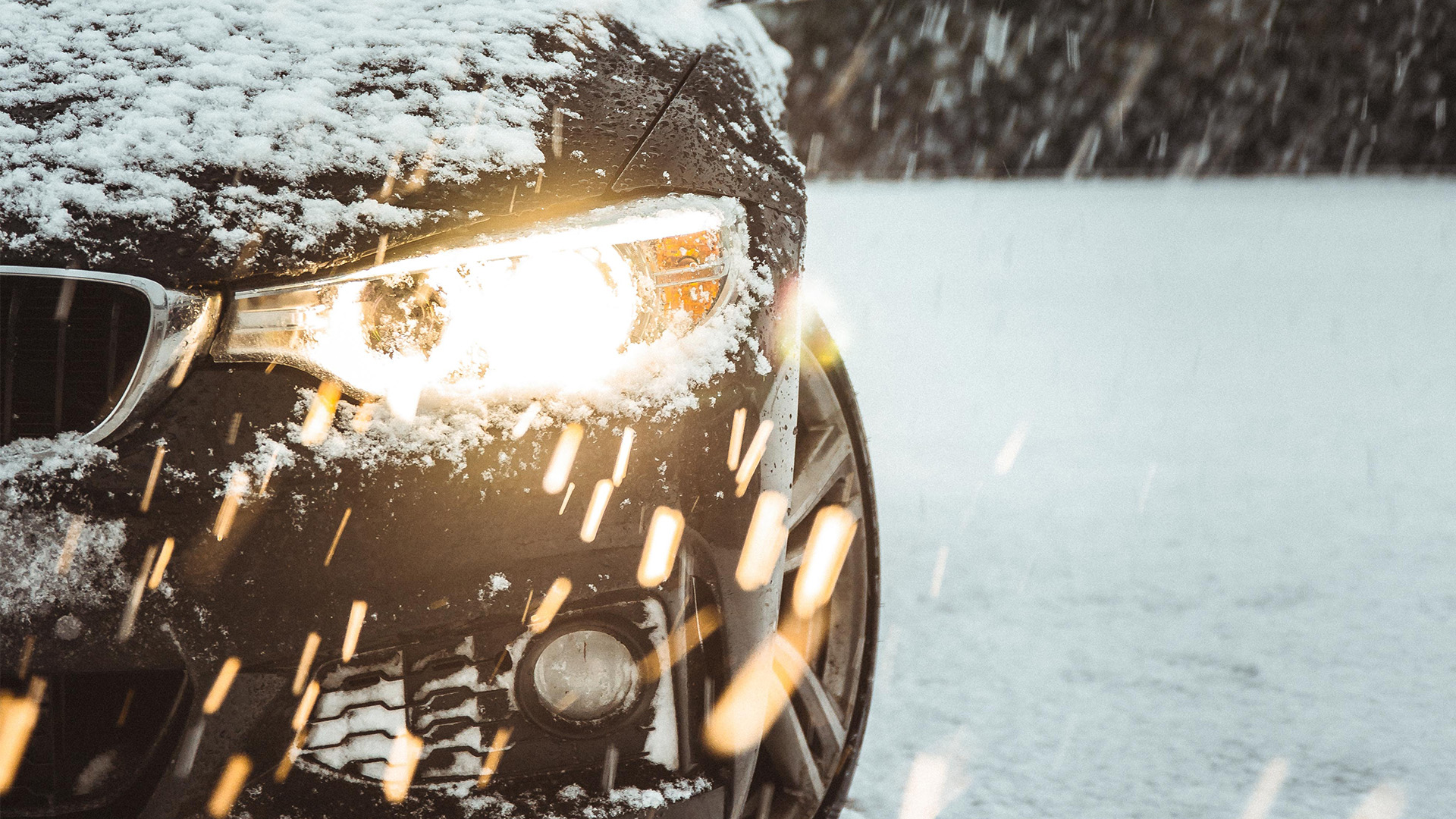 the headlight of a snow covered car